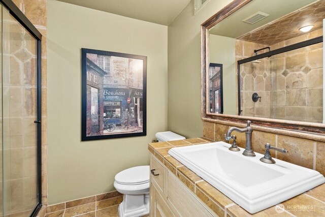 24635 8th Ave S, Des Moines, WA 98198 - full bath featuring toilet, a stall shower, tile patterned flooring, vanity, and baseboards