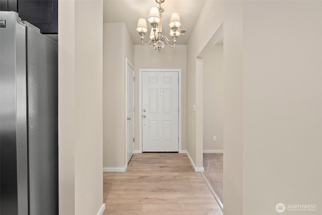 4914 Bering St, Gig Harbor, WA 98332 - corridor with a chandelier, light wood-style floors, and baseboards