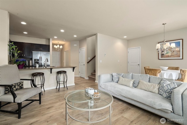 4914 Bering St, Gig Harbor, WA 98332 - living room with a chandelier, stairs, recessed lighting, light wood-style flooring, and baseboards
