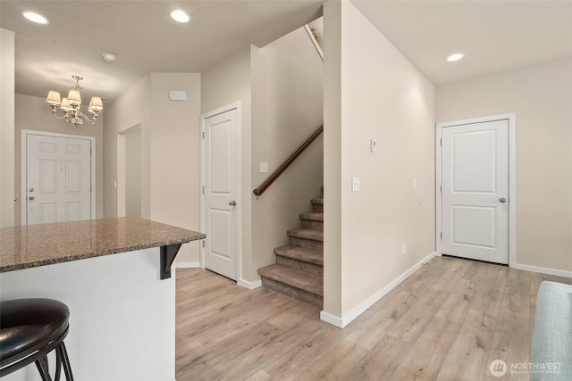 4914 Bering St, Gig Harbor, WA 98332 - kitchen featuring a breakfast bar area, light wood finished floors, a chandelier, baseboards, and recessed lighting