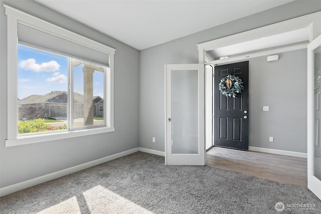 foyer with carpet, baseboards, and french doors