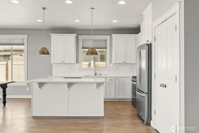 kitchen featuring appliances with stainless steel finishes, recessed lighting, white cabinets, and light countertops