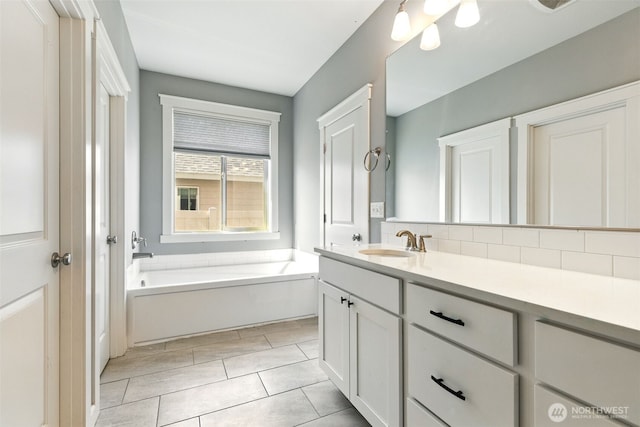 full bathroom featuring vanity, a bath, and decorative backsplash
