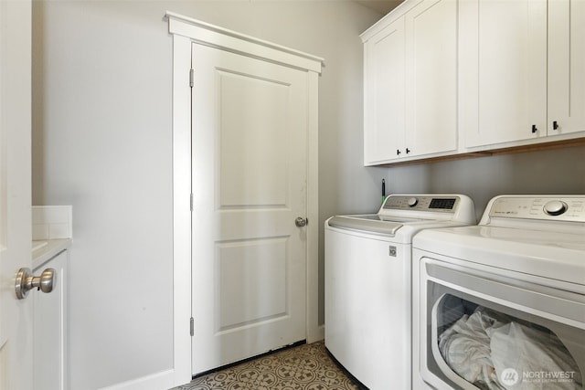 washroom with washing machine and dryer and cabinet space