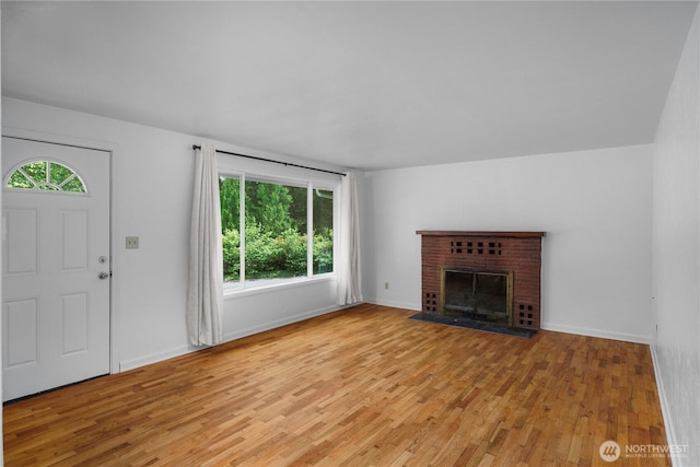 2116 Union Ave SE, Olympia, WA 98501 - unfurnished living room with light wood-style flooring, baseboards, and a fireplace