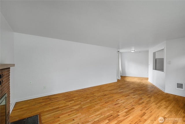 2116 Union Ave SE, Olympia, WA 98501 - unfurnished living room featuring a fireplace, light wood-style floors, and baseboards