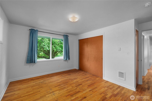 2116 Union Ave SE, Olympia, WA 98501 - unfurnished bedroom featuring light wood-style floors, a closet, and baseboards