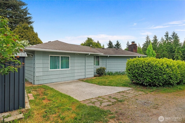 2116 Union Ave SE, Olympia, WA 98501 - rear view of house with roof with shingles, a patio area, and a yard