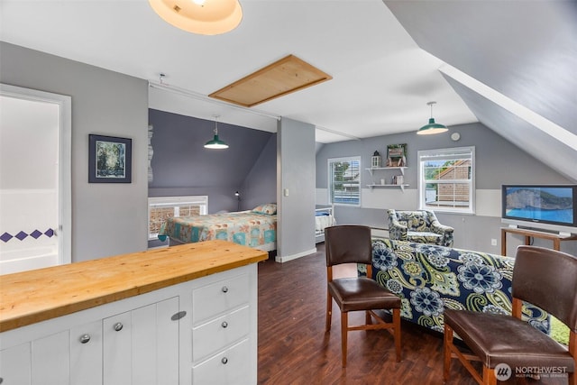 office space featuring lofted ceiling, dark wood-style flooring, and baseboards
