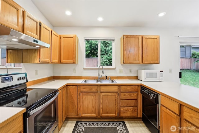 12515 NE 107th Pl, Kirkland, WA 98033 - kitchen with stainless steel electric stove, white microwave, a sink, black dishwasher, and under cabinet range hood