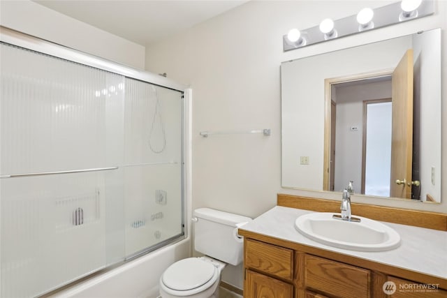 12515 NE 107th Pl, Kirkland, WA 98033 - bathroom featuring vanity, toilet, and bath / shower combo with glass door