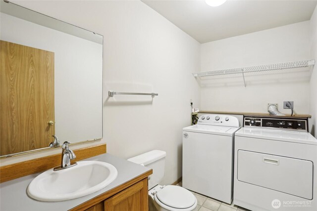 12515 NE 107th Pl, Kirkland, WA 98033 - half bath featuring independent washer and dryer, toilet, vanity, and tile patterned floors