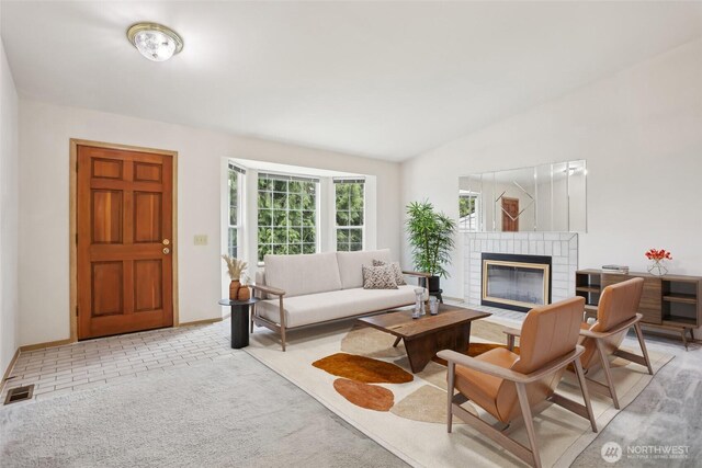 12515 NE 107th Pl, Kirkland, WA 98033 - living area featuring a fireplace, lofted ceiling, and baseboards