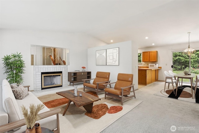 12515 NE 107th Pl, Kirkland, WA 98033 - living room with a fireplace, vaulted ceiling, light colored carpet, and recessed lighting