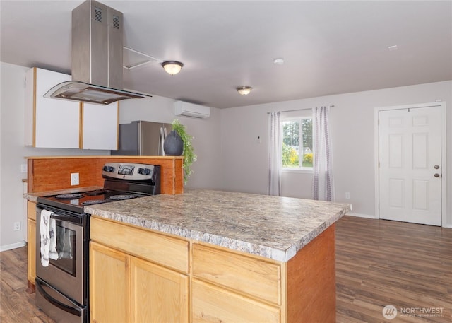1138 W 17th, Port Angeles, WA 98363 - kitchen with stainless steel appliances, island range hood, a wall mounted AC, dark wood-style flooring, and baseboards