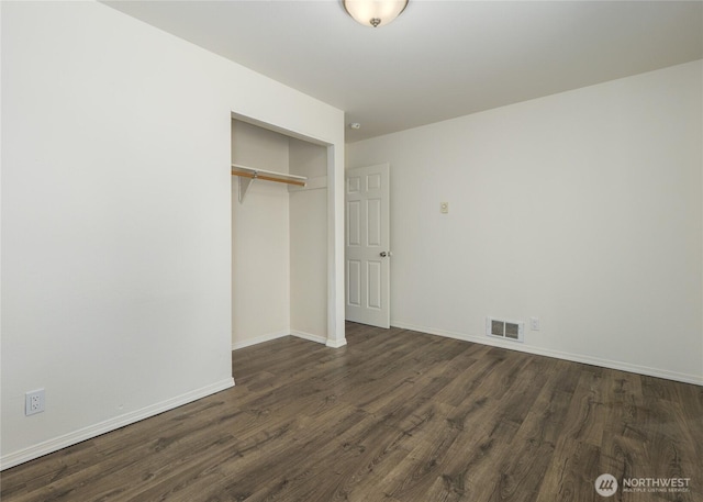 1138 W 17th, Port Angeles, WA 98363 - unfurnished bedroom featuring dark wood-type flooring, a closet, and baseboards