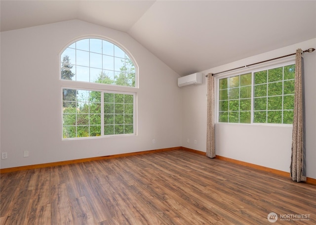 1138 W 17th, Port Angeles, WA 98363 - unfurnished room with a wall mounted AC, plenty of natural light, lofted ceiling, baseboards, and wood finished floors