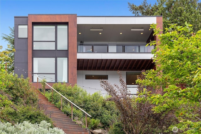 7734 Seward Park Ave S, Seattle, WA 98118 - rear view of house featuring a balcony, stairway, and stucco siding