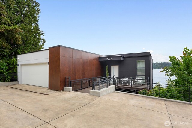 7734 Seward Park Ave S, Seattle, WA 98118 - view of front facade with a garage and a water view