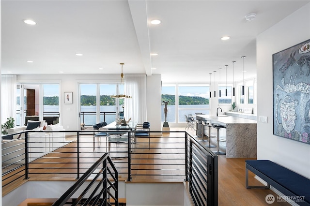 7734 Seward Park Ave S, Seattle, WA 98118 - hall featuring wood finished floors, plenty of natural light, a water view, and recessed lighting