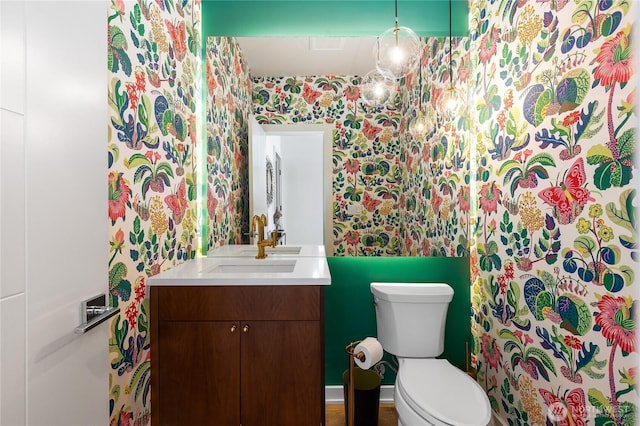 7734 Seward Park Ave S, Seattle, WA 98118 - bathroom featuring wallpapered walls, toilet, and vanity