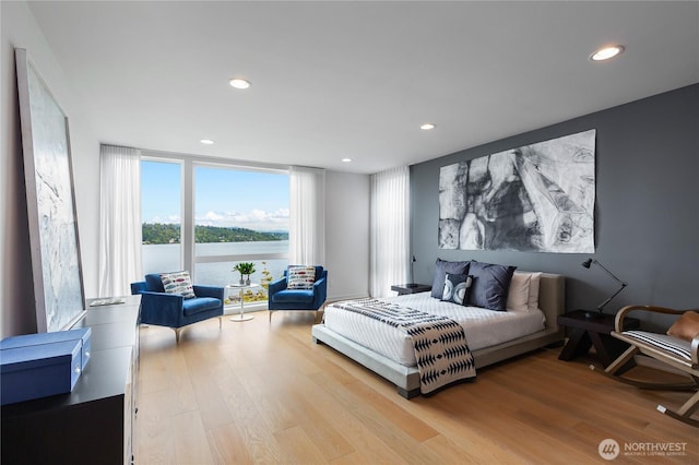 7734 Seward Park Ave S, Seattle, WA 98118 - bedroom featuring wood finished floors, recessed lighting, floor to ceiling windows, and a water view