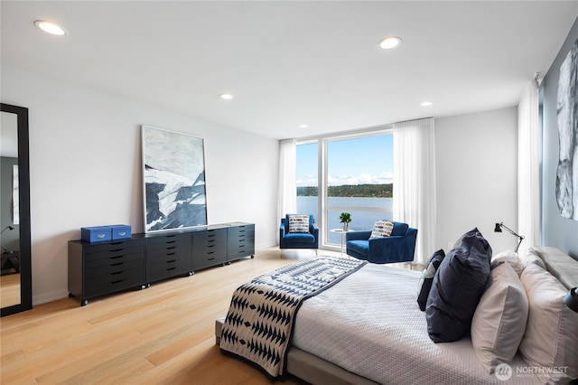 7734 Seward Park Ave S, Seattle, WA 98118 - bedroom with wood finished floors, recessed lighting, and a water view