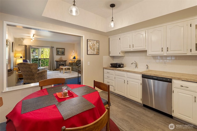 250 Tucker Ave Unit 25, Friday Harbor, WA 98250 - kitchen with stainless steel dishwasher, a sink, white cabinetry, and dark wood-style floors