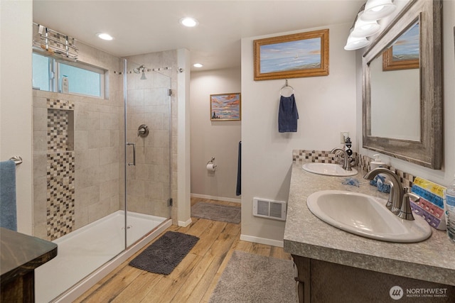 250 Tucker Ave Unit 25, Friday Harbor, WA 98250 - full bathroom with a stall shower, wood finished floors, baseboards, double vanity, and recessed lighting