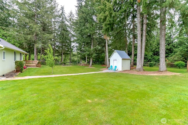 161 Malinka Ln, Chehalis, WA 98532 - view of grassy yard featuring a storage unit, an outbuilding, a wooden deck, and view of scattered trees