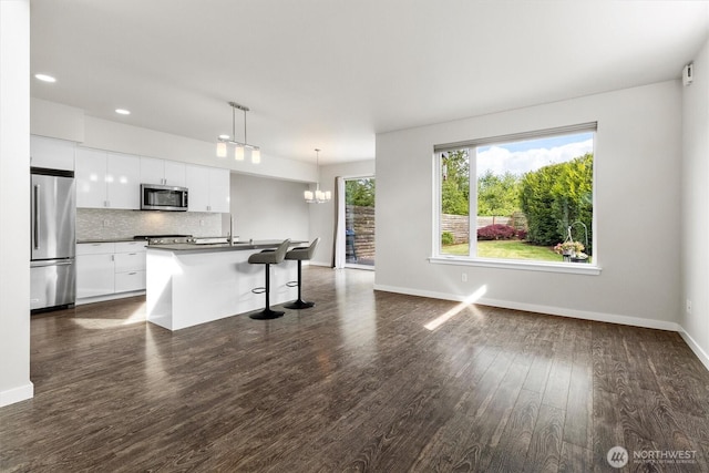 4720 Spring Vista Way, Bellingham, WA 98226 - kitchen featuring stainless steel appliances, white cabinets, decorative backsplash, baseboards, and dark countertops