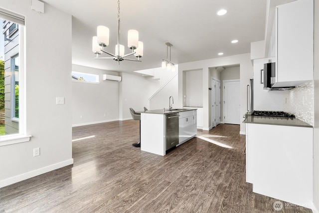 4720 Spring Vista Way, Bellingham, WA 98226 - kitchen with appliances with stainless steel finishes, a wall unit AC, white cabinets, dark countertops, and dark wood-style flooring