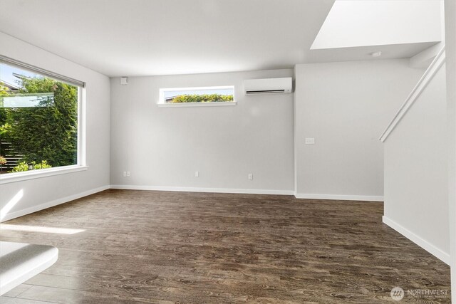 4720 Spring Vista Way, Bellingham, WA 98226 - empty room with a wall unit AC, wood finished floors, healthy amount of natural light, and baseboards