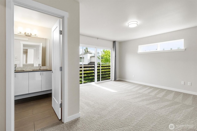 4720 Spring Vista Way, Bellingham, WA 98226 - spare room featuring a sink, carpet flooring, and baseboards