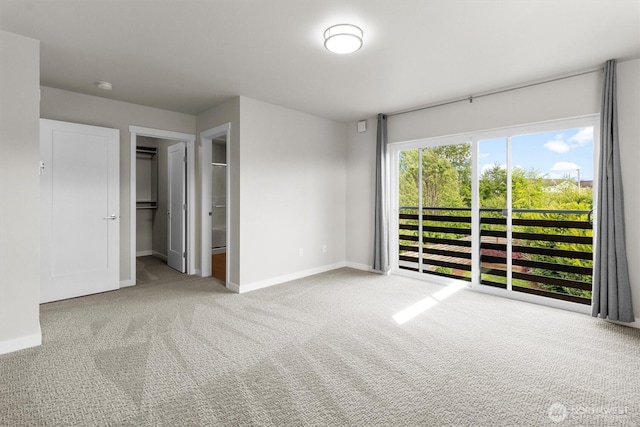 4720 Spring Vista Way, Bellingham, WA 98226 - unfurnished bedroom featuring carpet flooring, baseboards, a walk in closet, and access to exterior