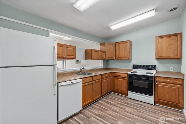 2404 Sumner Ave, Aberdeen, WA 98520 - kitchen featuring white appliances, a sink, light wood finished floors, brown cabinetry, and light countertops