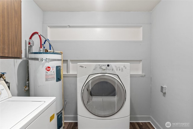 2404 Sumner Ave, Aberdeen, WA 98520 - laundry area with dark wood finished floors, electric water heater, washer and clothes dryer, and baseboards