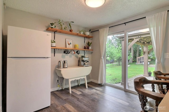 19411 67th St E, Bonney Lake, WA 98391 - kitchen with freestanding refrigerator, a textured ceiling, dark wood-style floors, open shelves, and baseboards