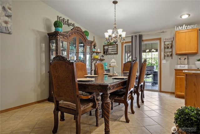 985 S 10th Ave, Othello, WA 99344 - dining space featuring a chandelier, light tile patterned floors, and baseboards