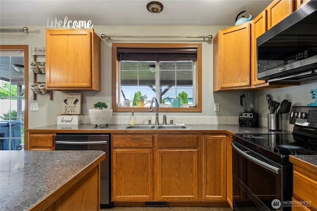 985 S 10th Ave, Othello, WA 99344 - kitchen featuring black range with electric cooktop, a sink, stainless steel dishwasher, and plenty of natural light