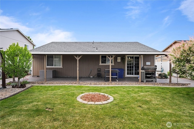 985 S 10th Ave, Othello, WA 99344 - rear view of house featuring a patio area, a lawn, and a shingled roof