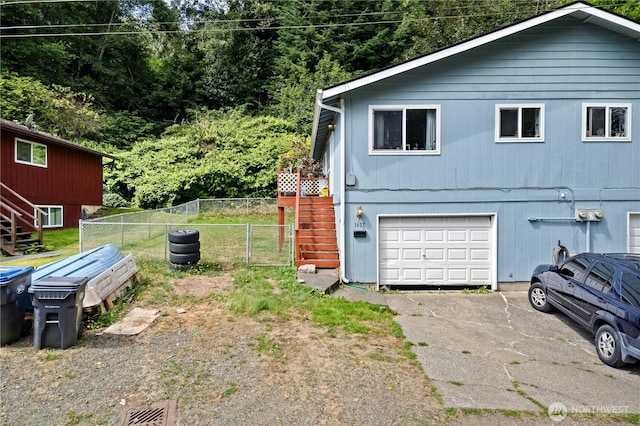 1607 N C St, Aberdeen, WA 98520 - view of side of home with a garage, asphalt driveway, and stairs