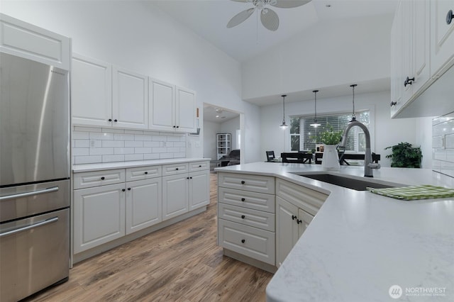 1392 Myers Dr, Ferndale, WA 98248 - kitchen with freestanding refrigerator, a sink, ceiling fan, light countertops, and tasteful backsplash