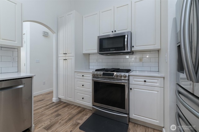 1392 Myers Dr, Ferndale, WA 98248 - kitchen with stainless steel appliances, backsplash, light countertops, and white cabinets