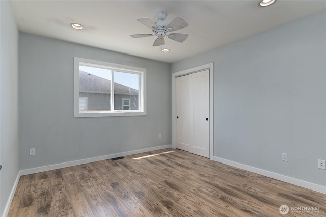 1392 Myers Dr, Ferndale, WA 98248 - unfurnished bedroom with baseboards, wood finished floors, a closet, recessed lighting, and ceiling fan