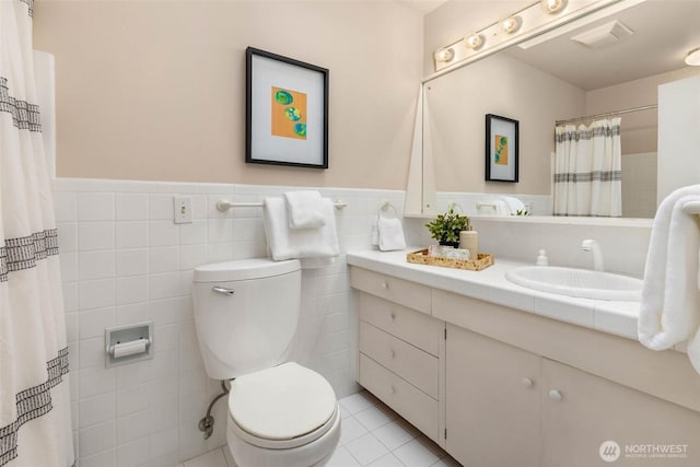 7915 SE 34th St, Mercer Island, WA 98040 - full bath featuring toilet, tile walls, wainscoting, vanity, and tile patterned floors