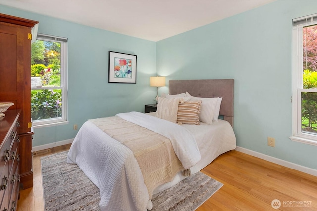 7915 SE 34th St, Mercer Island, WA 98040 - bedroom with multiple windows, baseboards, and light wood-type flooring