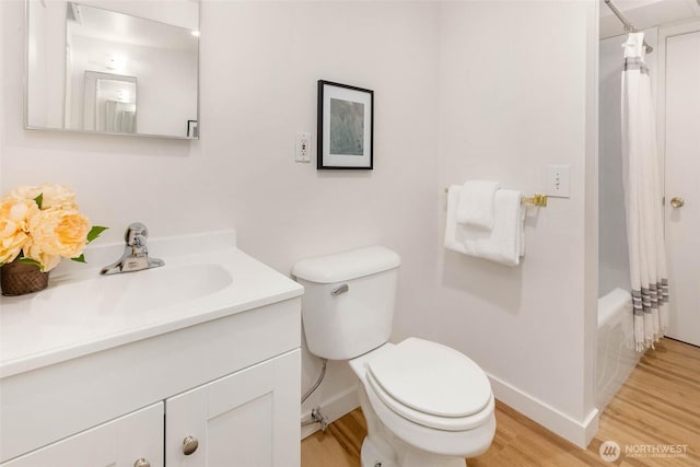 7915 SE 34th St, Mercer Island, WA 98040 - full bath with wood finished floors, toilet, baseboards, vanity, and shower / bath combo