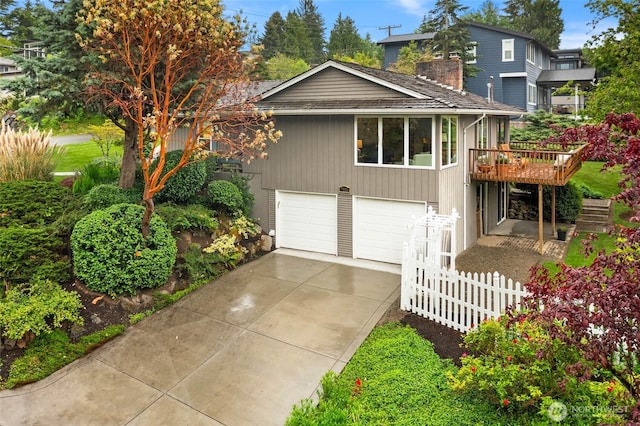 7915 SE 34th St, Mercer Island, WA 98040 - view of front of house with a chimney, driveway, a garage, a wooden deck, and fence