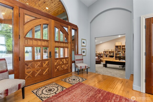 7342 Huckleberry Rd NW, Olympia, WA 98502 - entryway with wood finished floors, healthy amount of natural light, a high ceiling, arched walkways, and baseboards
